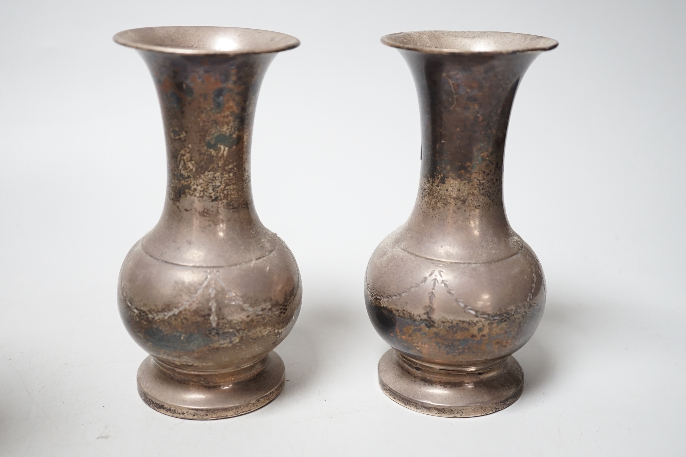 A pair of George V silver mounted spill vases, Birmingham, 1934, 14.2cm, weighted.